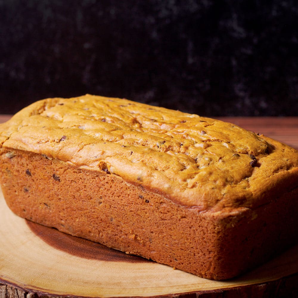 A freshly baked loaf of pumpkin chocolate chip bread.
