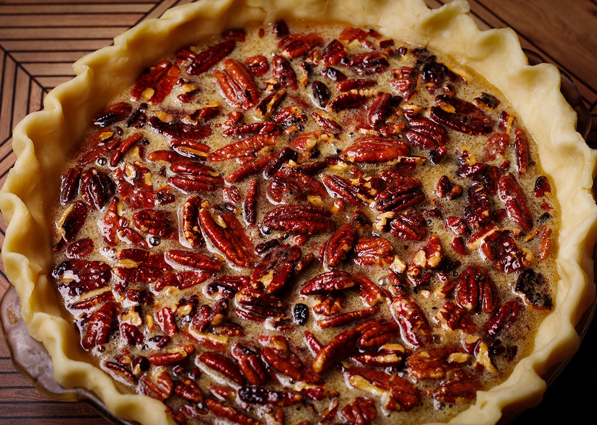 An unbaked pecan pie that's ready to go into the oven.