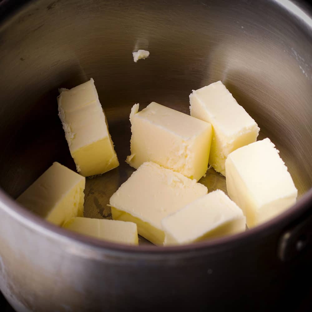 Chunks of butter in a saucepan.