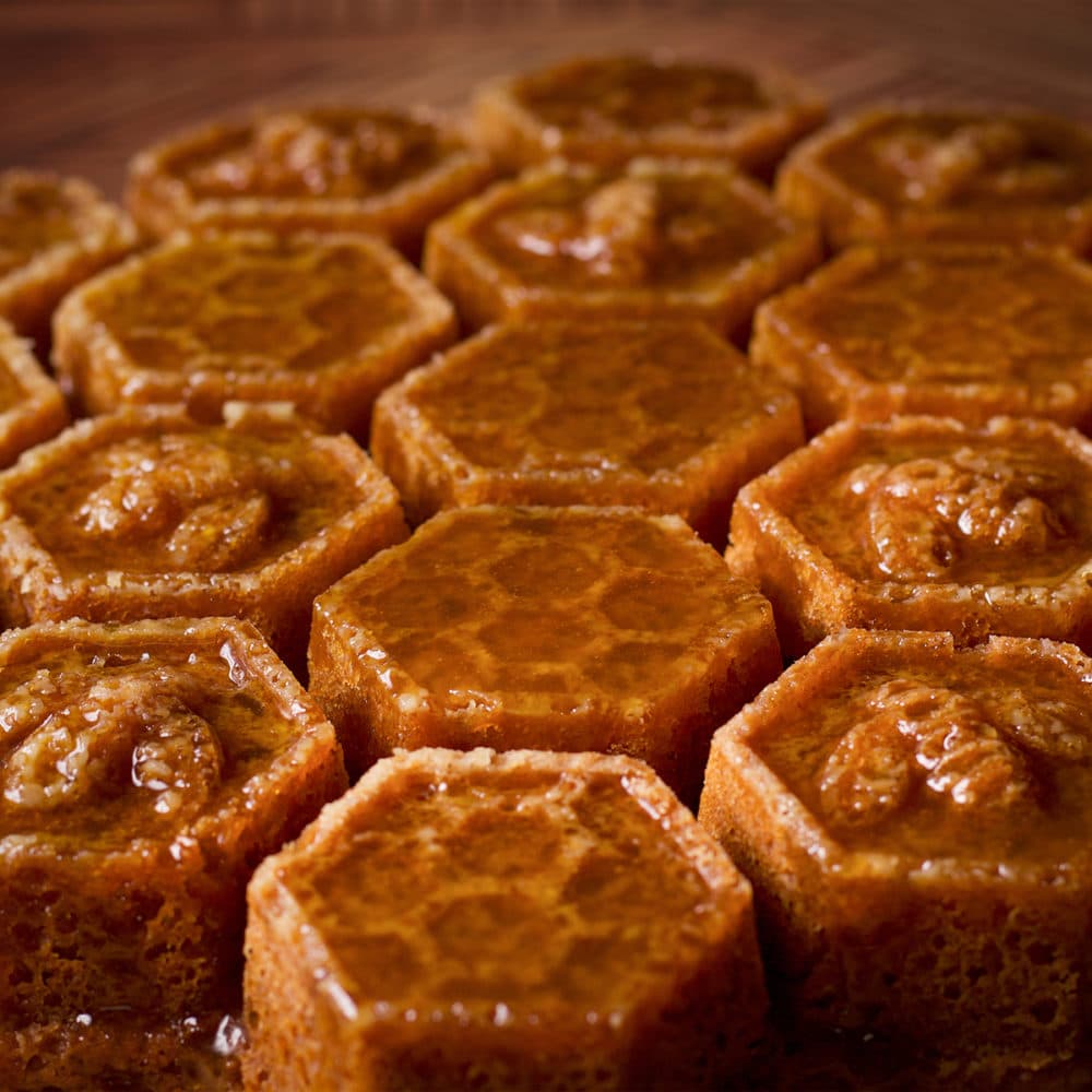 A honey cake, baked in a honeycomb pan, that's been covered in whisky sauce.