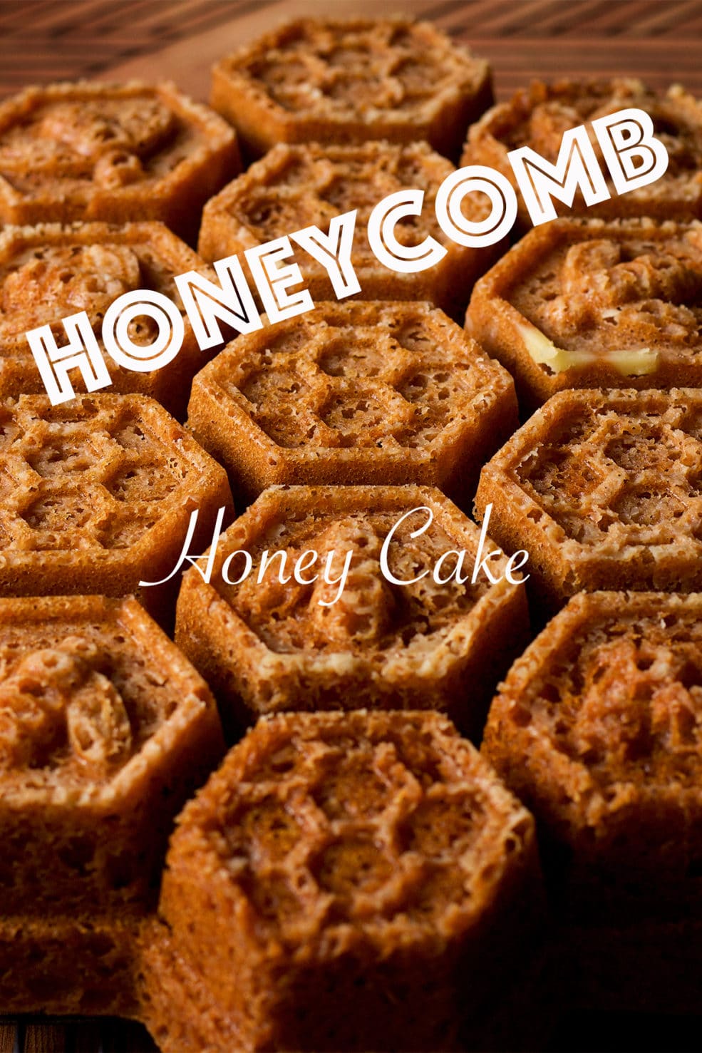A freshly baked Honey Cake, baked in a Honeycomb Pan, on a wood serving tray.