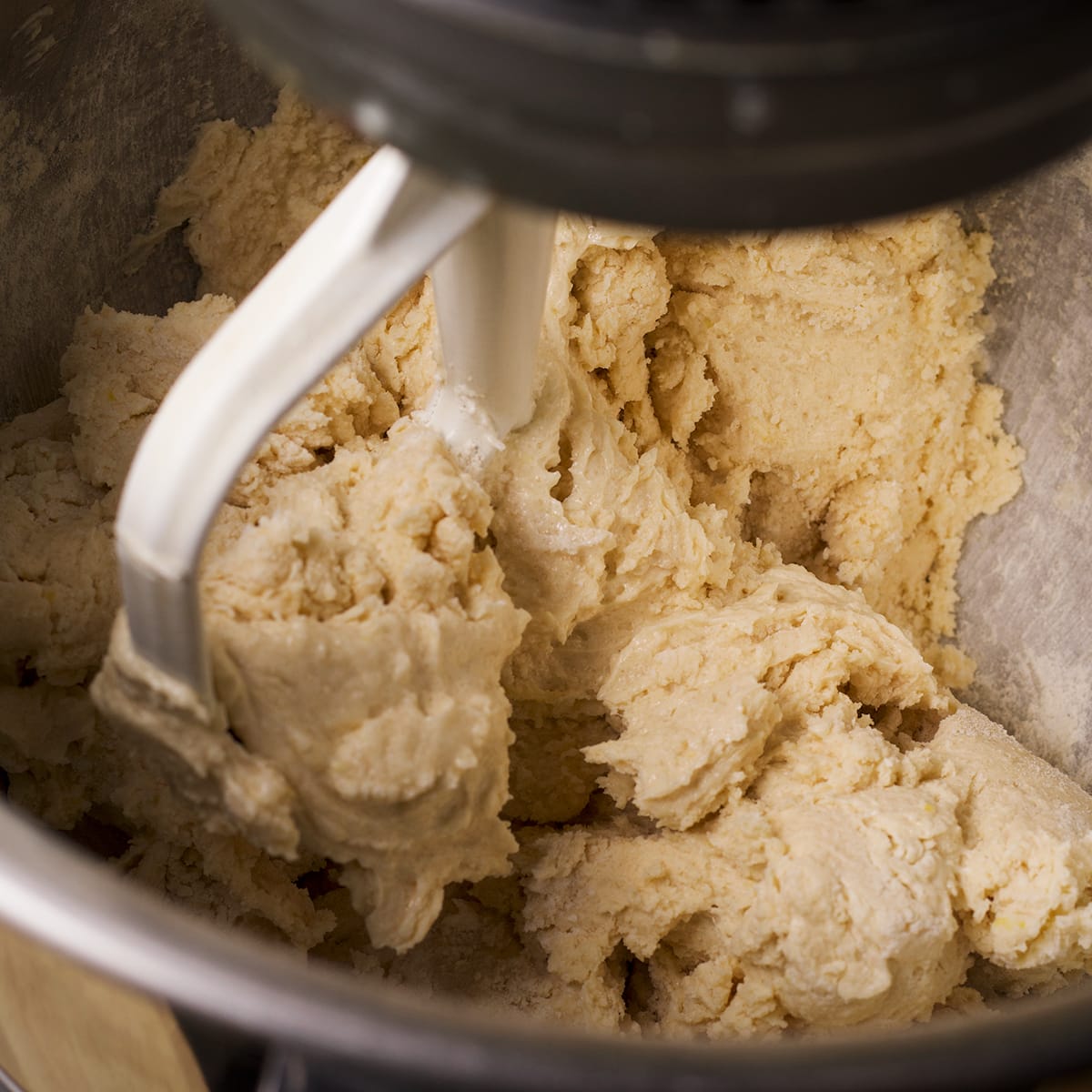 An electric stand mixer beating cookie dough.