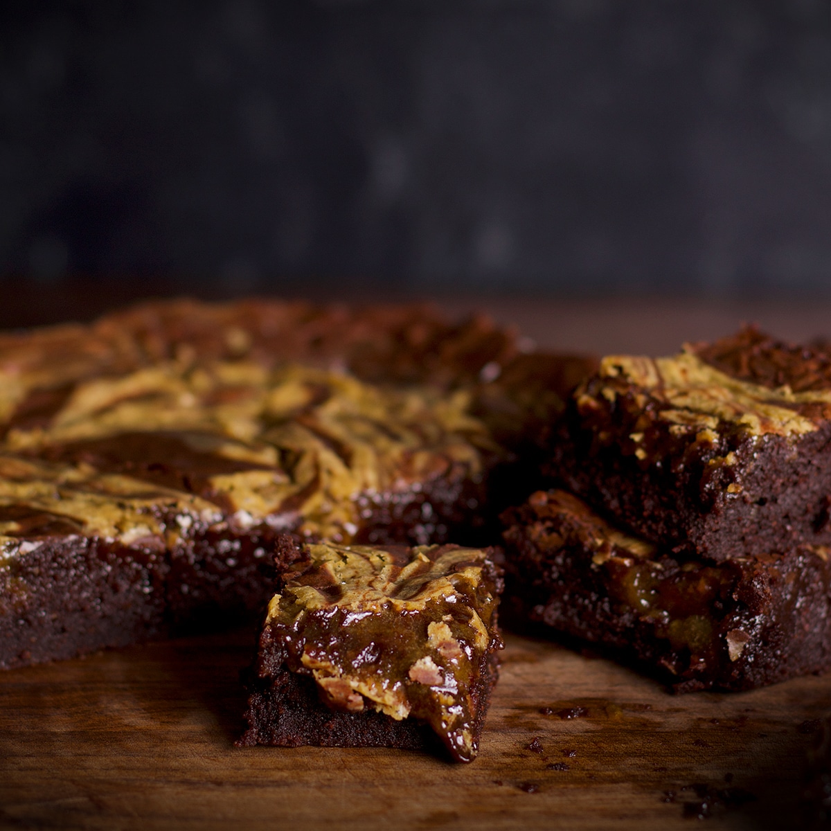 A close up photo of freshly baked tahini brownies so you can see their fudgy texture.