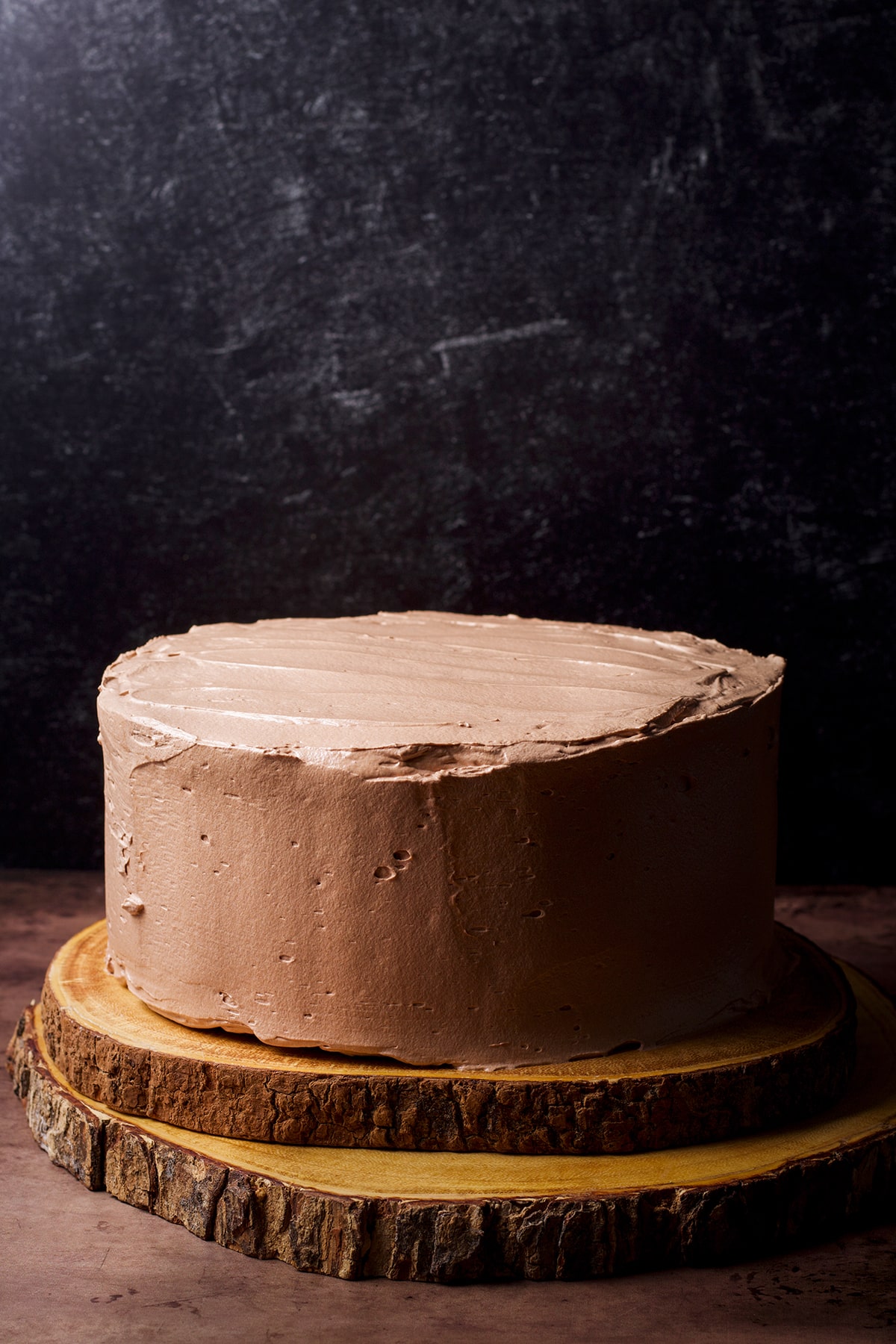 A 2-layer chocolate truffle cake that's been filled and frosted with milk chocolate buttercream.