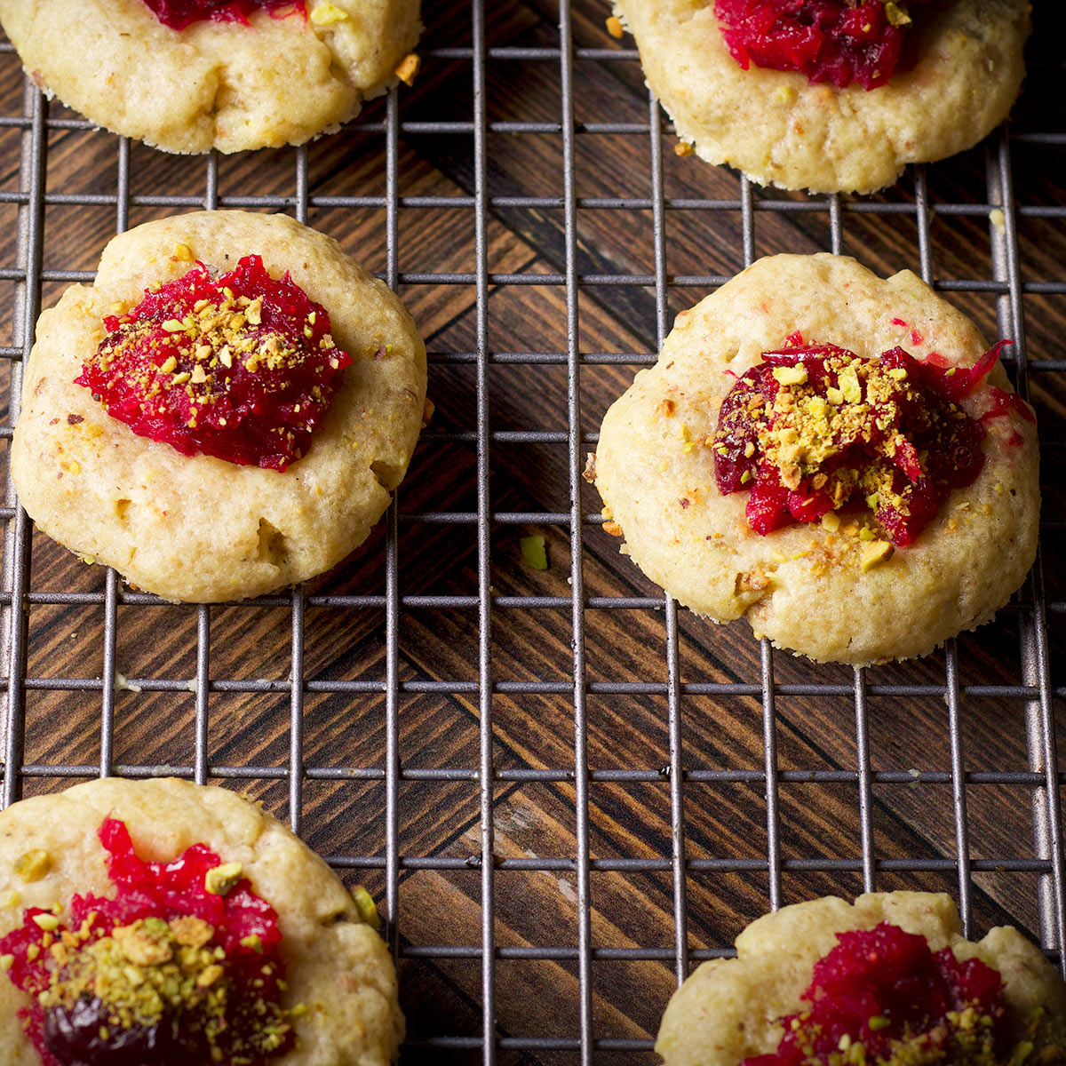 Cranberry pistachio cookies cooling on a wire baking rack.