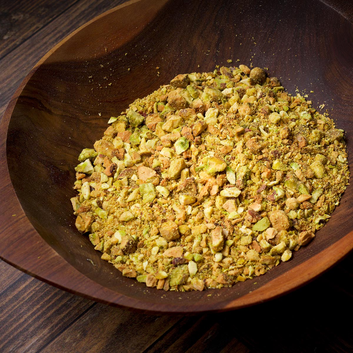 A bowl containing chopped pistachios.