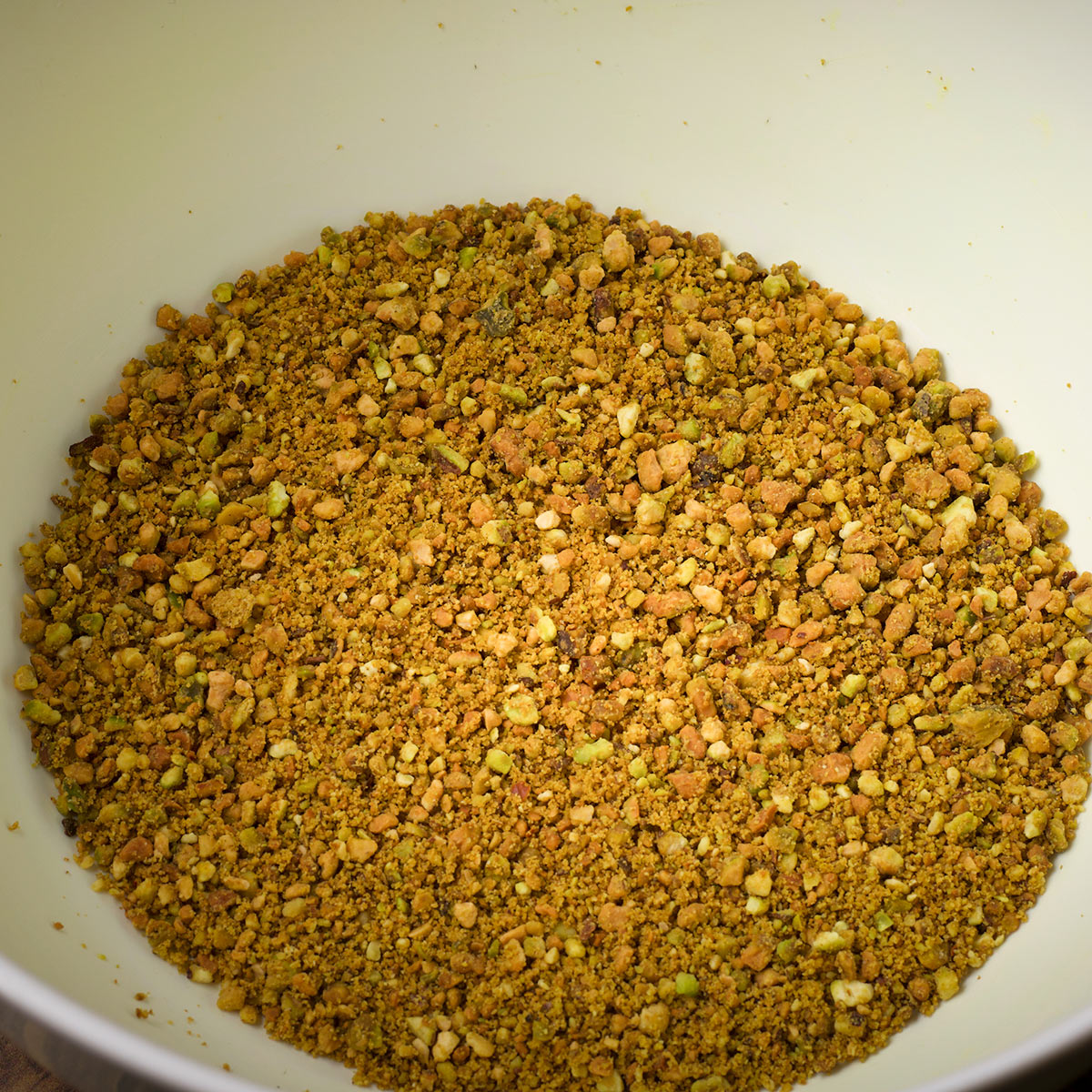 A bowl containing ground pistachios.