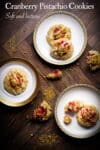 Three small plates containing cranberry pistachio cookies.