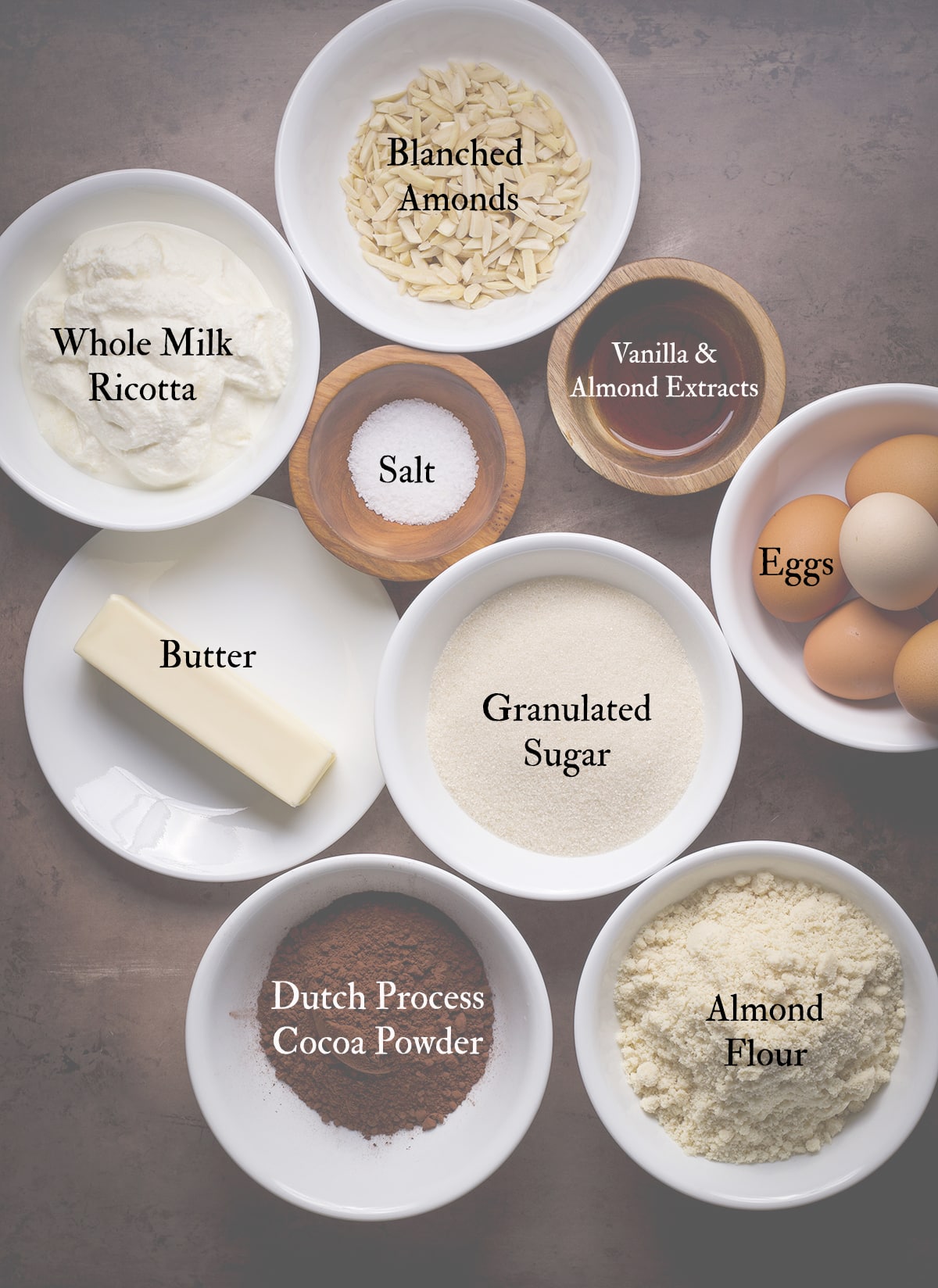 All the ingredients needed to bake a flourless chocolate ricotta cake with almond flour.