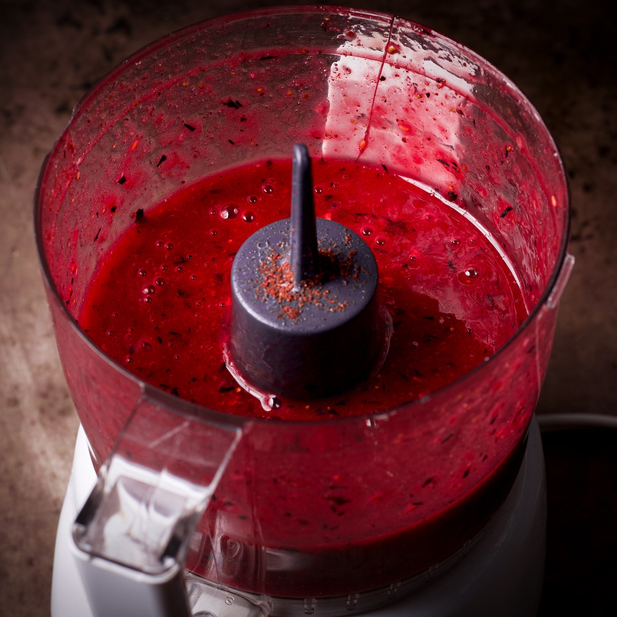 Berry coulis in the bowl of a food processor.