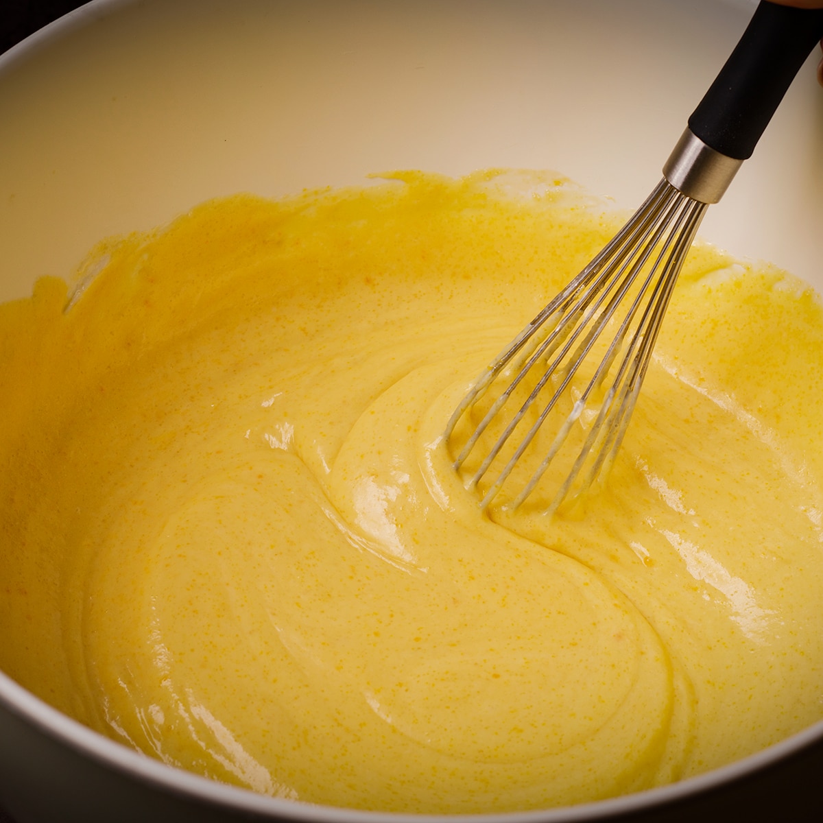 Using a wire whisk to mix muffin batter.