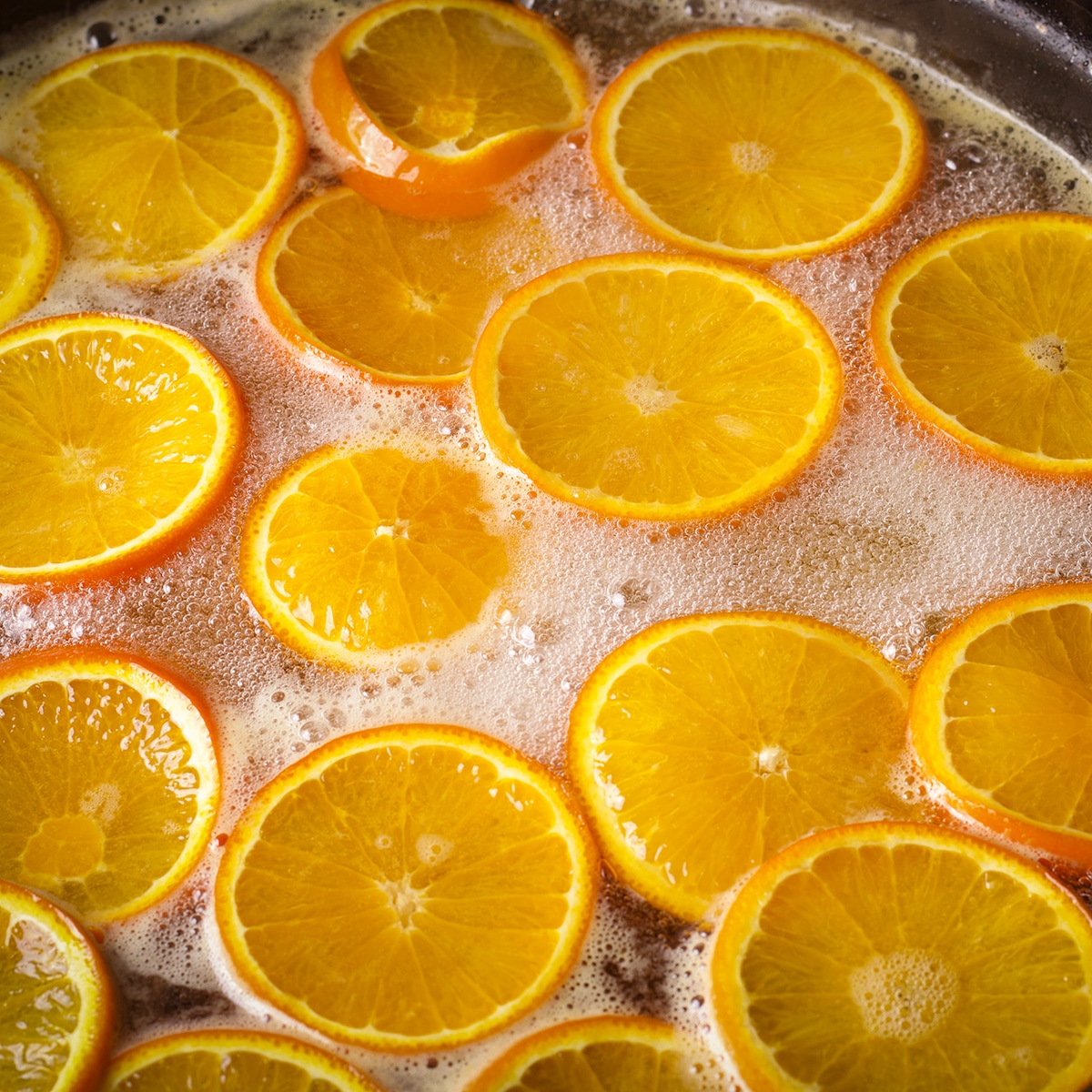 Orange slices simmering in simple syrup.