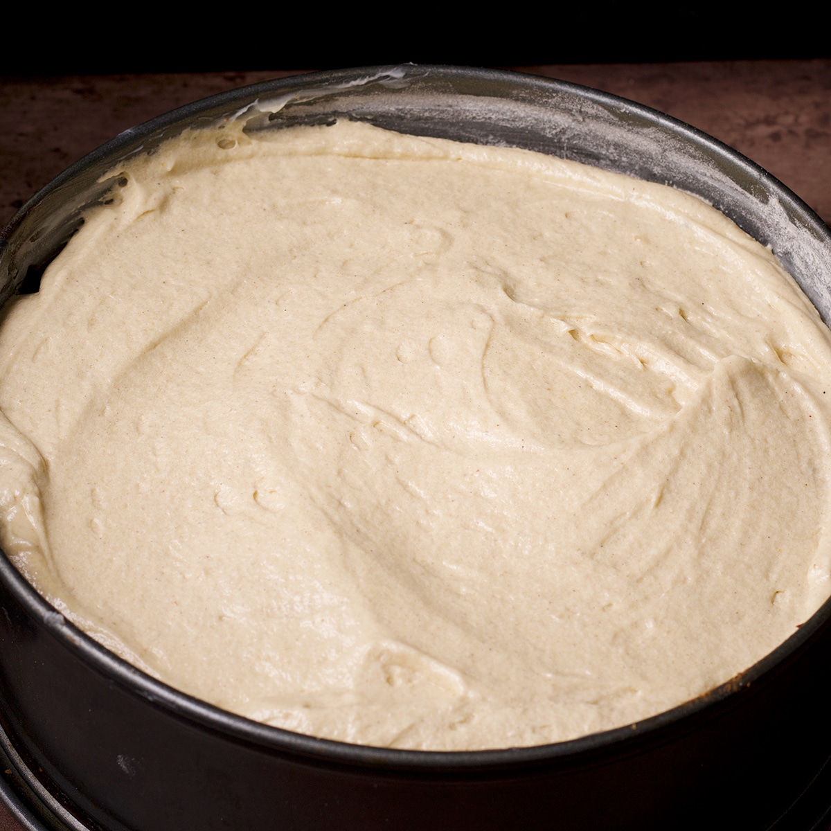 A springform pan filled with cake batter.