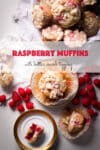 Raspberry muffins on a table surrounded by fresh raspberries.