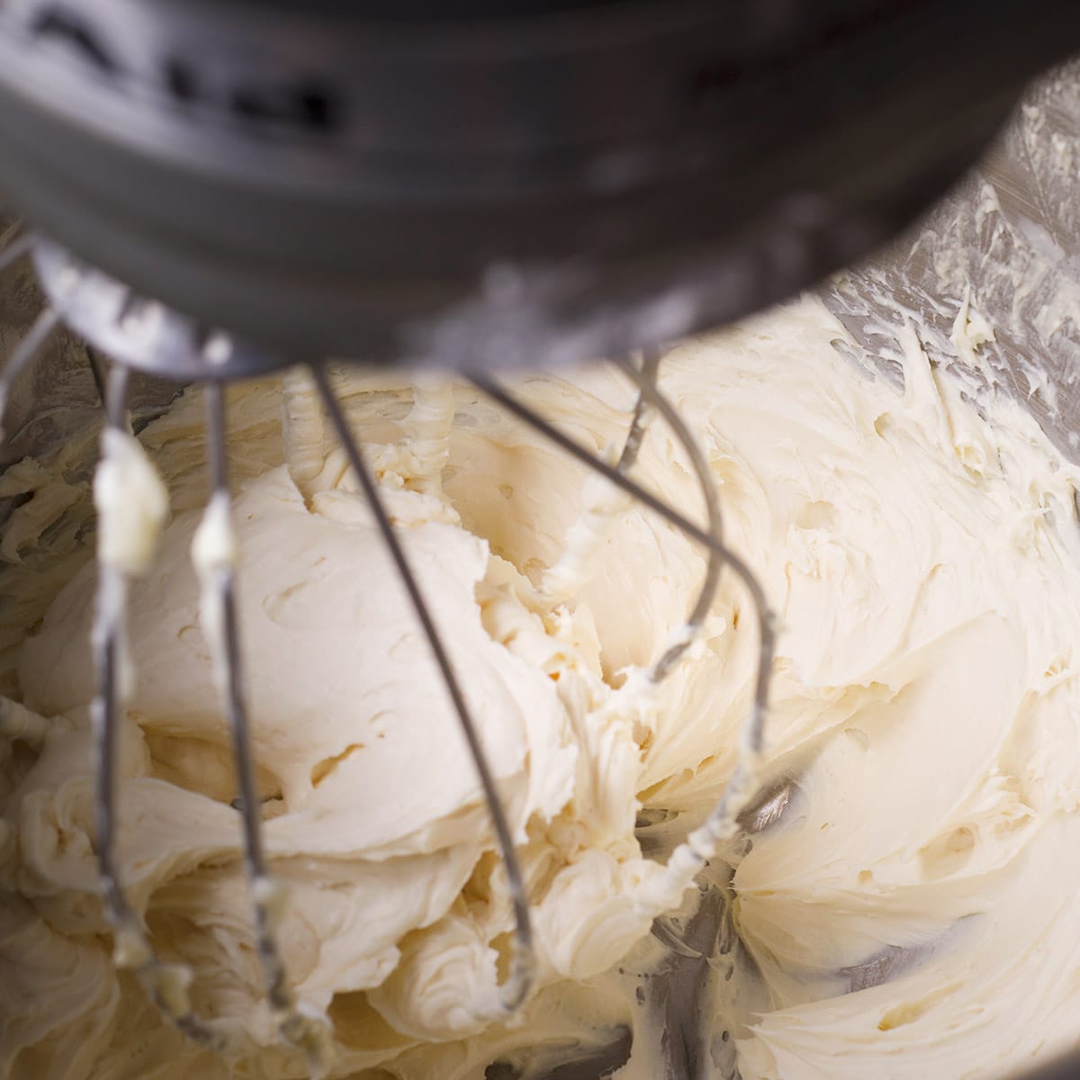 Using an electric mixer to beat cream cheese, butter, salt, and vanilla.