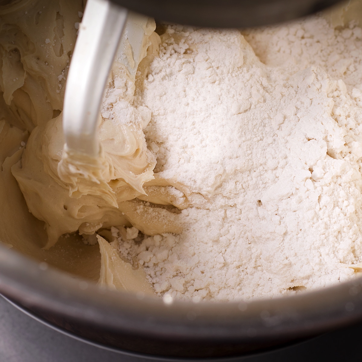 Gently mixing cake flour into the batter.