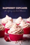Several raspberry cupcakes topped with a swirl of raspberry cream cheese buttercream.