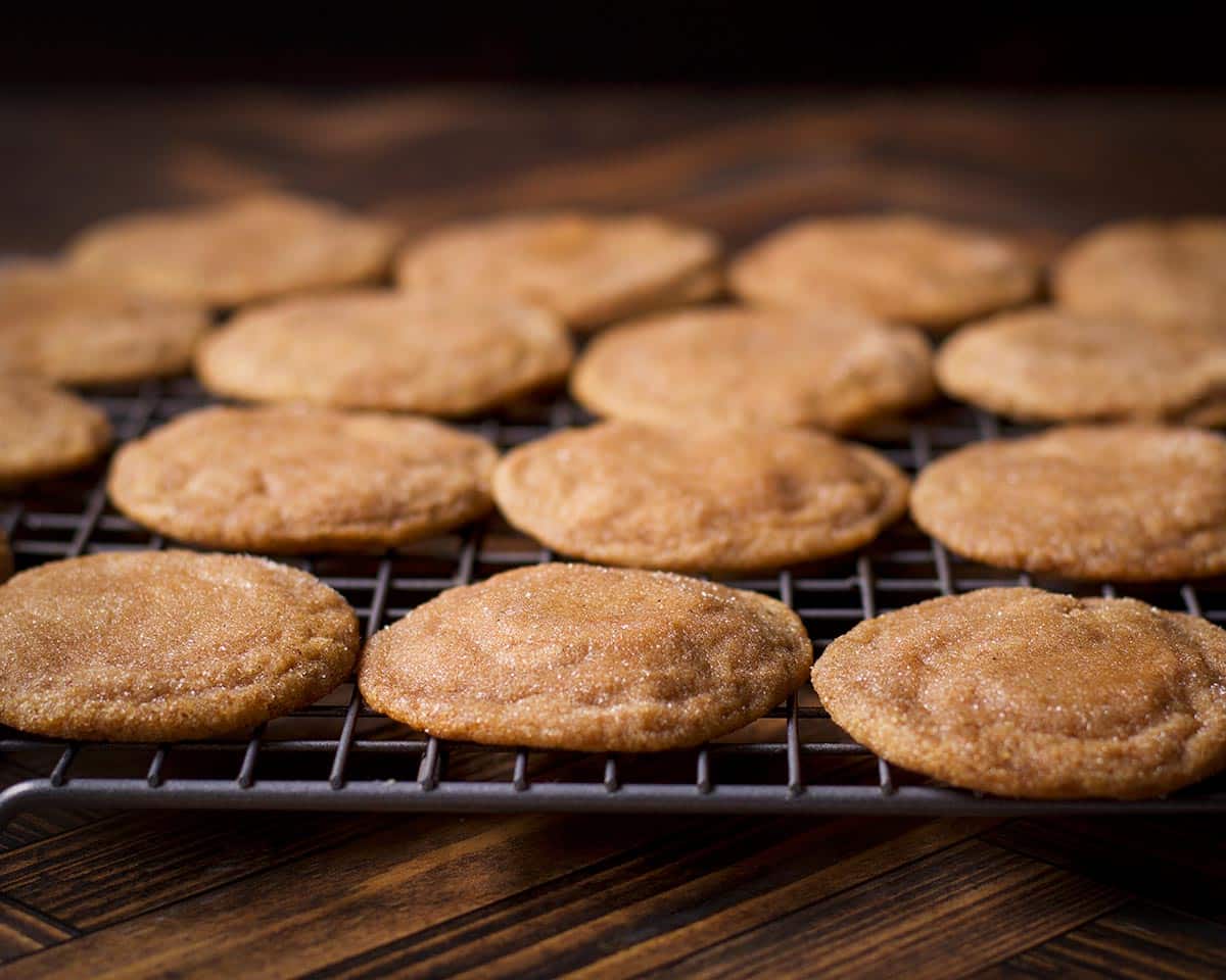 Freshly baked vanilla bean brown sugar cookies cooling on a wire rack.