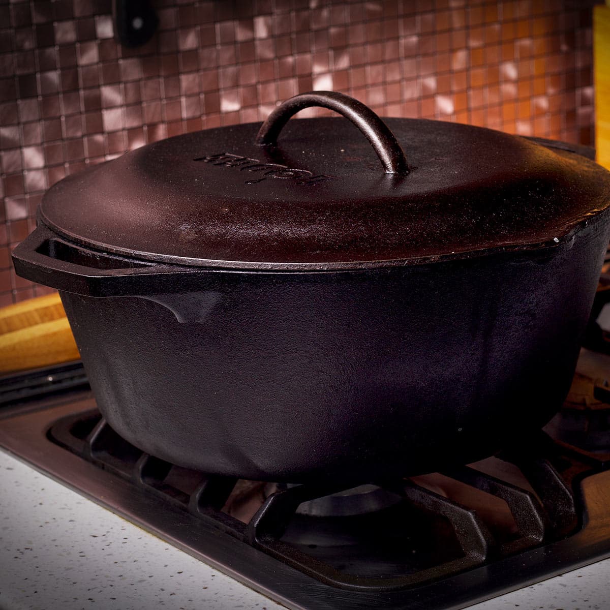 A cast iron Dutch oven on a stove top.