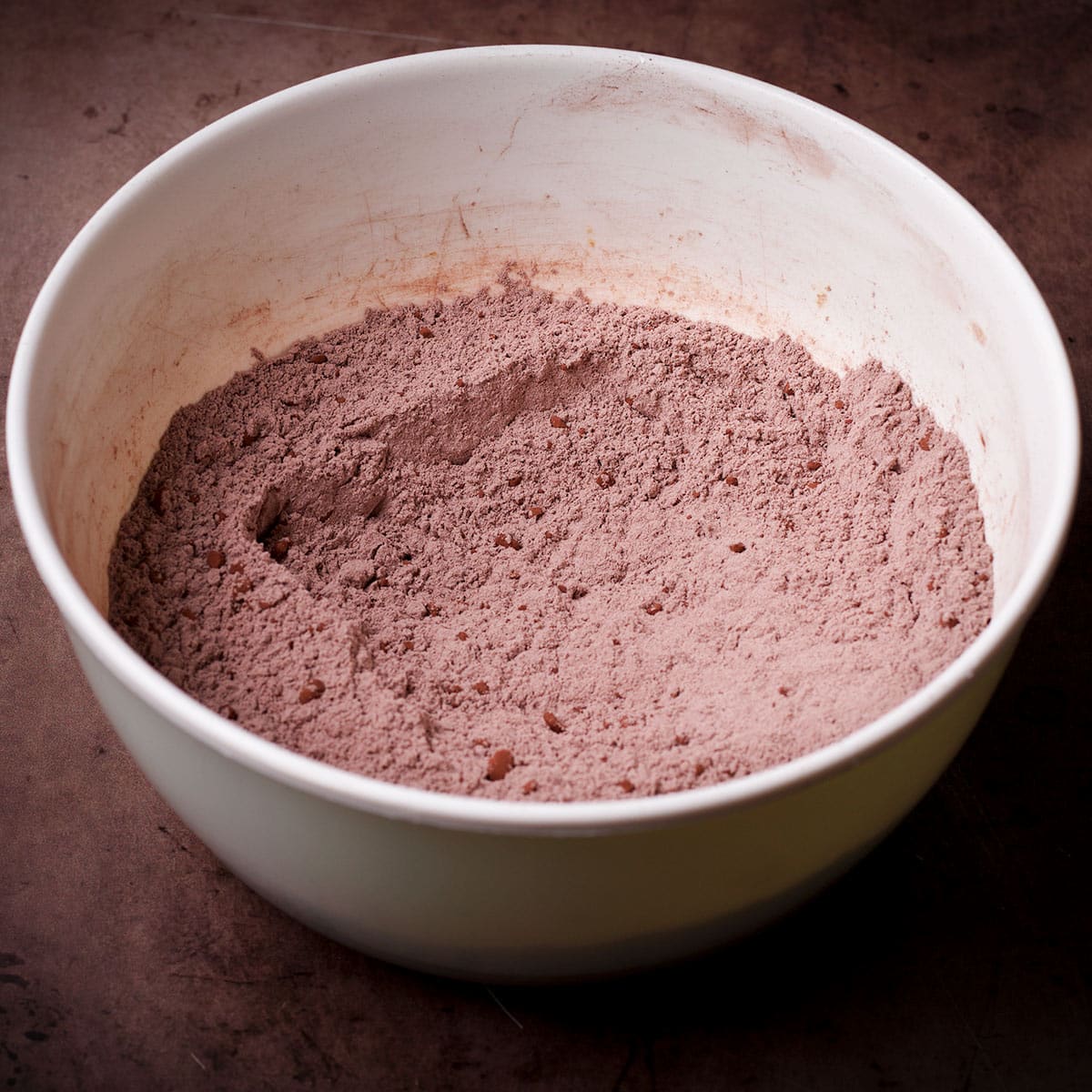 All the dry ingredients used in this Dutch oven chocolate cake recipe mixed together in a mixing bowl.