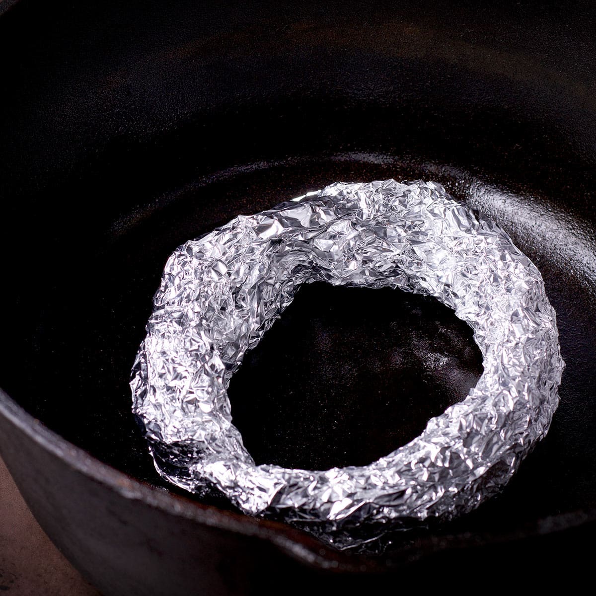 A ring of foil placed on the bottom of a Dutch oven.