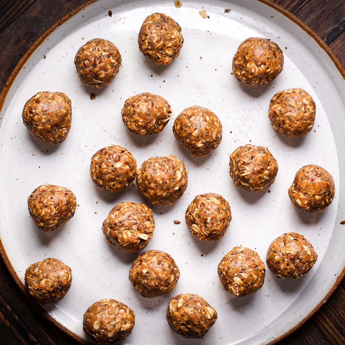A plate of protein bites that have just been shaped into balls.
