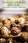 Different flavors of protein balls on a plate, some covered in dark chocolate and some drizzled with white chocolate, and some filled with chocolate chips.